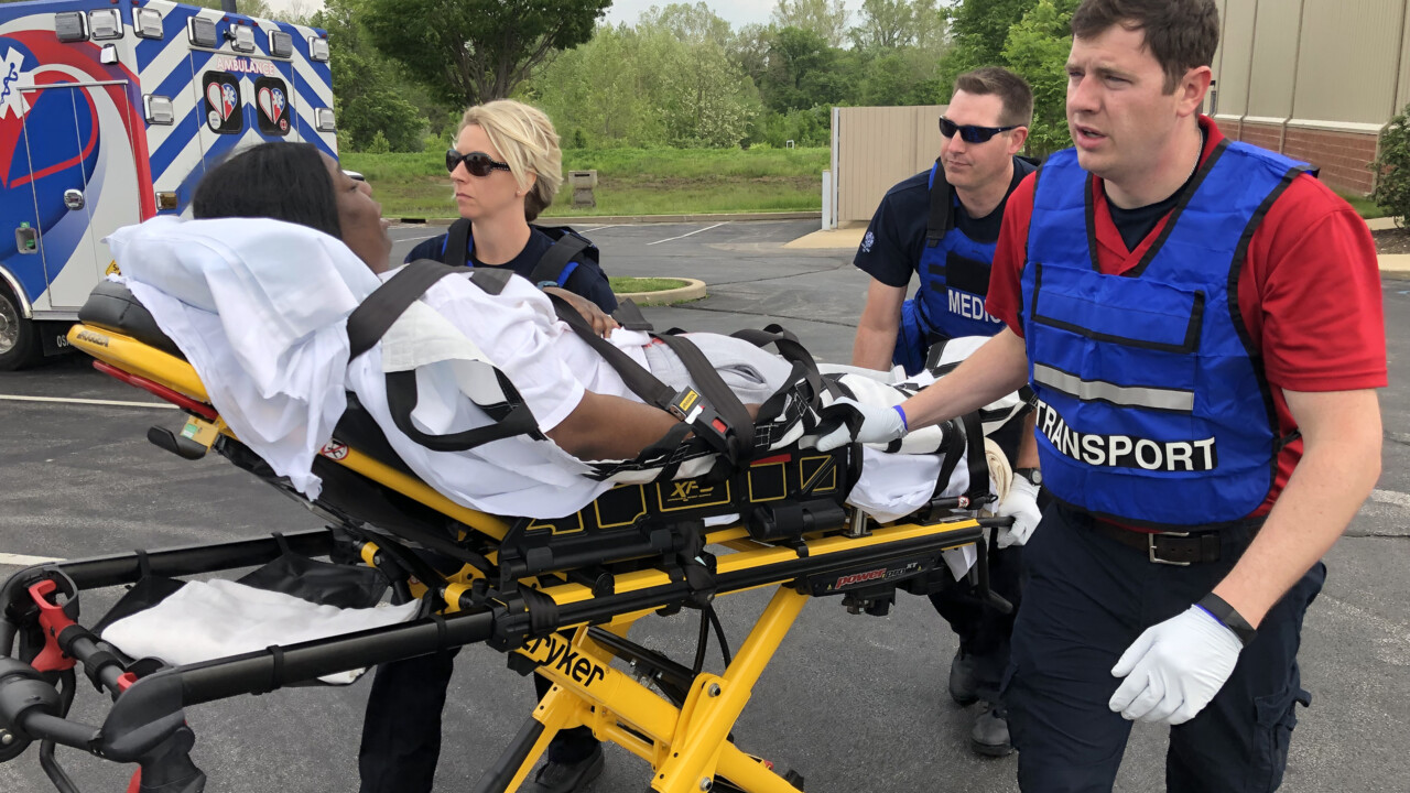 Paramedics transporting patient